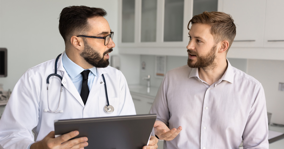 Doctor explaining hormone evaluation during testosterone replacement therapy consultation