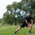 Man stretching outdoors after discovering how long does TRT take to work through consistent testosterone replacement therapy