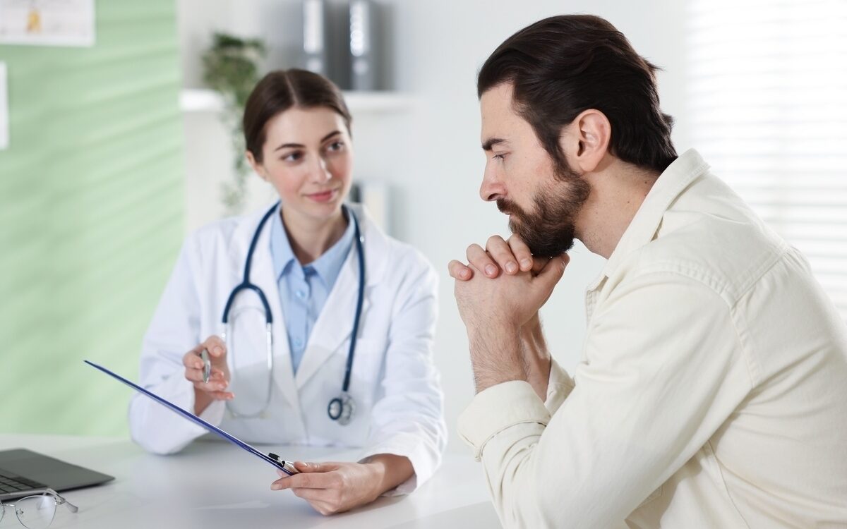 Man discussing TRT injections vs pellets vs gels with his healthcare provider during a consultation