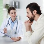 Man discussing TRT injections vs pellets vs gels with his healthcare provider during a consultation