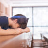 Man experiencing common signs of male hormone imbalance including fatigue and low energy